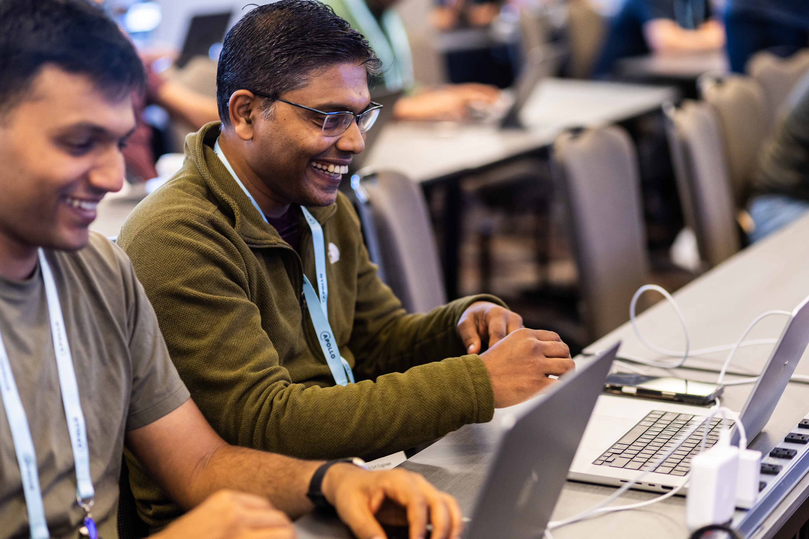 An attendee working on a laptop during a Summit hackathon.